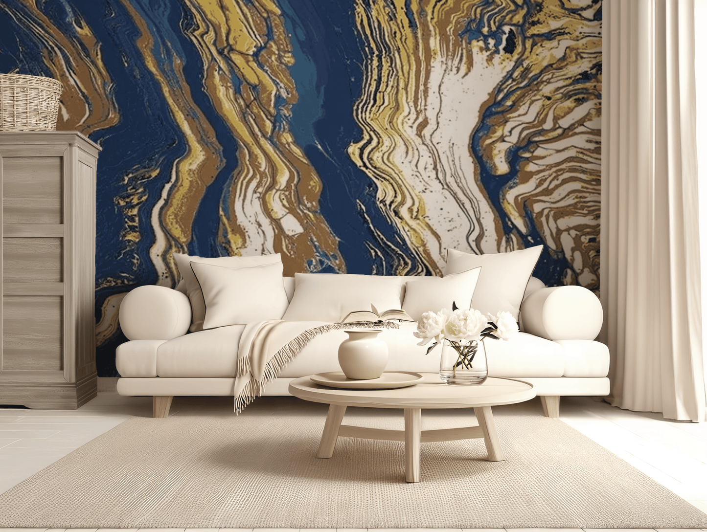 A living room scene with a Blue and Gold Abstract Lines Mural covering the wall behind the sofa and extending into the ceiling, with a wooden cabinet to the left and a light-colored sofa in the center in front of a white curtain.