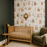 Whimsical bunny nursery mural wallpaper featuring hand-painted rabbits, pastel florals, and woodland elements, styled in a nursery with natural wood crib.
