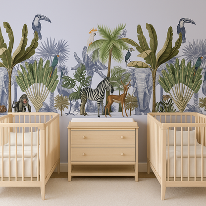 Neutral jungle nursery mural wallpaper featuring illustrated palm trees, tropical leaves, and exotic animals including zebra, antelope, monkey, parrots, toucans, and elephants. Styled in a twin nursery with two wooden cribs and neutral changing unit.