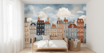 Bedroom with a wall mural of colorful houses and clouds