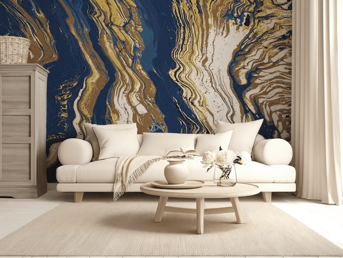 A living room scene with a Blue and Gold Abstract Lines Mural covering the wall behind the sofa and extending into the ceiling, with a wooden cabinet to the left and a light-colored sofa in the center in front of a white curtain.