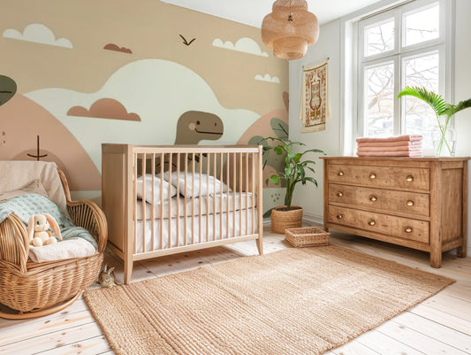 Neutral dinosaur nursery mural wallpaper featuring softly illustrated dinosaurs, earthy tones, desert hills and cacti, styled with wooden crib.