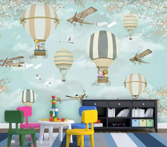 Blue cartoon plane and hot air balloon mural wallpaper in a children's nursery