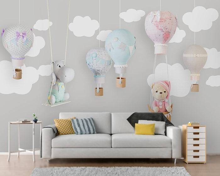 Grey and white clouds hot air balloon mural wallpaper in a nursery